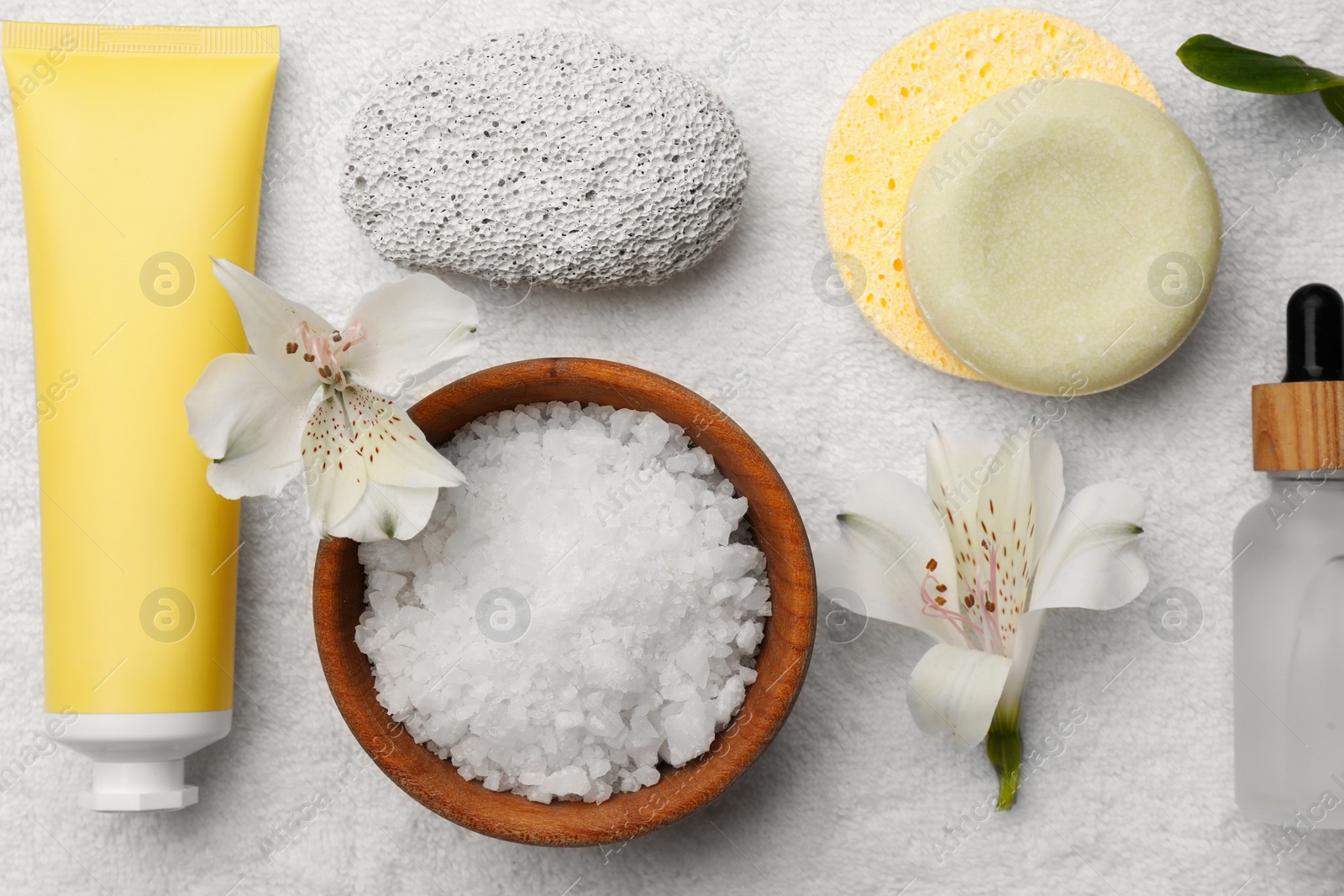 Photo of Flat lay composition with spa products and flowers on white towel