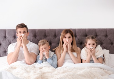 Photo of Family suffering from cold in bed at home