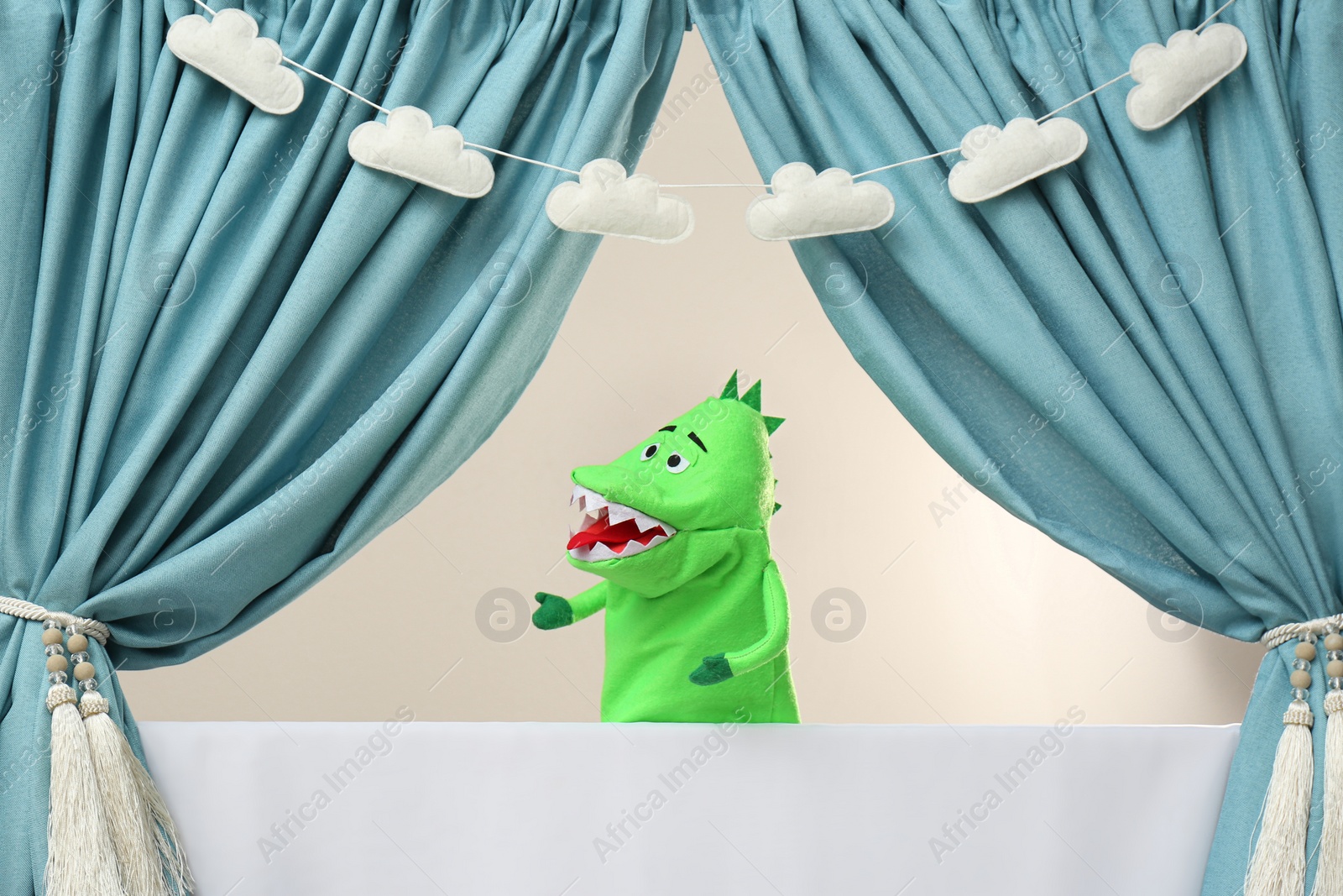 Photo of Creative puppet show on white stage indoors