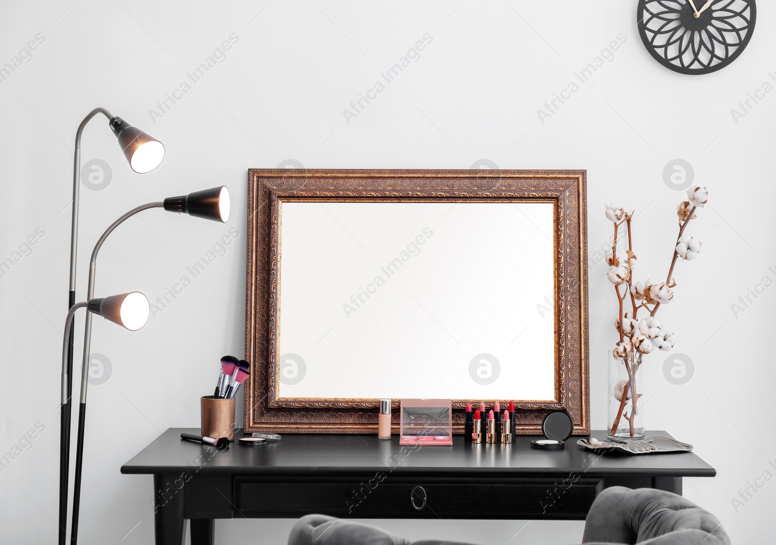 Photo of Decorative cosmetics and tools on dressing table near mirror in makeup room