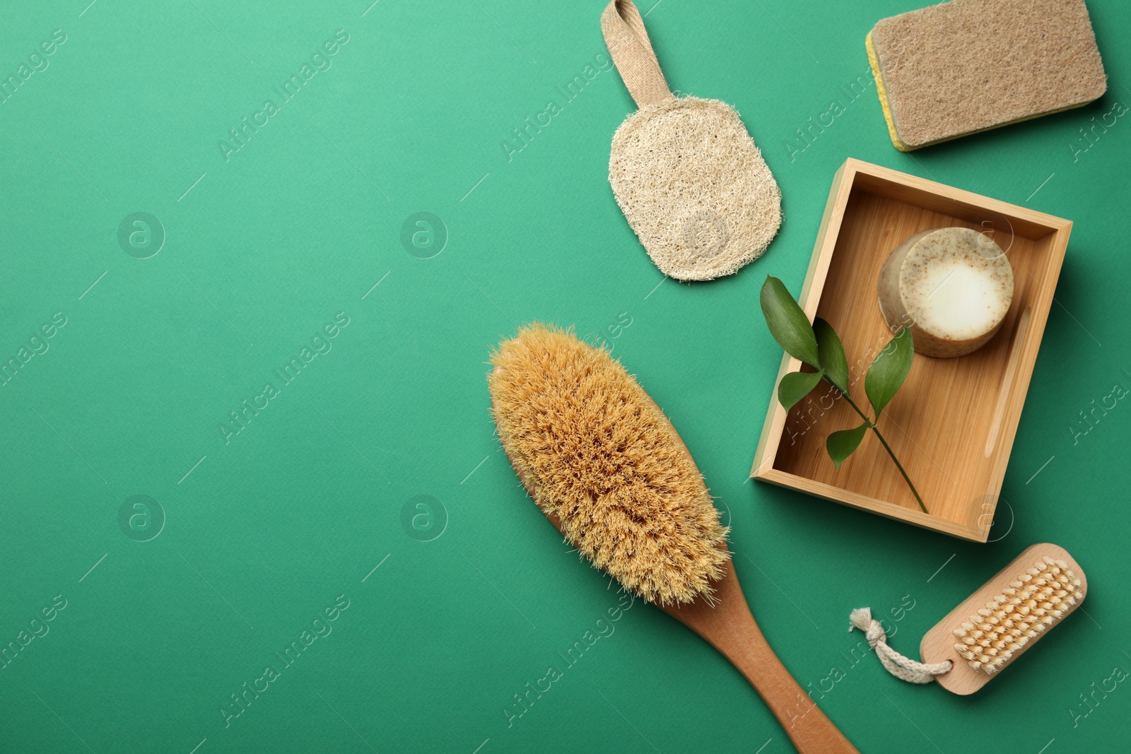 Photo of Flat lay composition with eco friendly products on green background, space for text. Conscious consumption