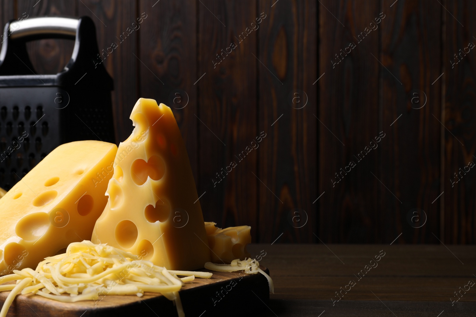 Photo of Tasty fresh cheese on wooden table, closeup. Space for text