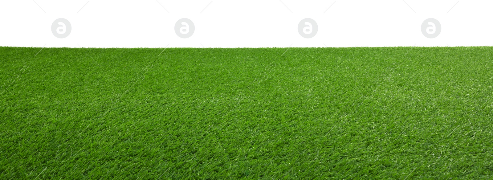 Photo of Green artificial grass surface isolated on white