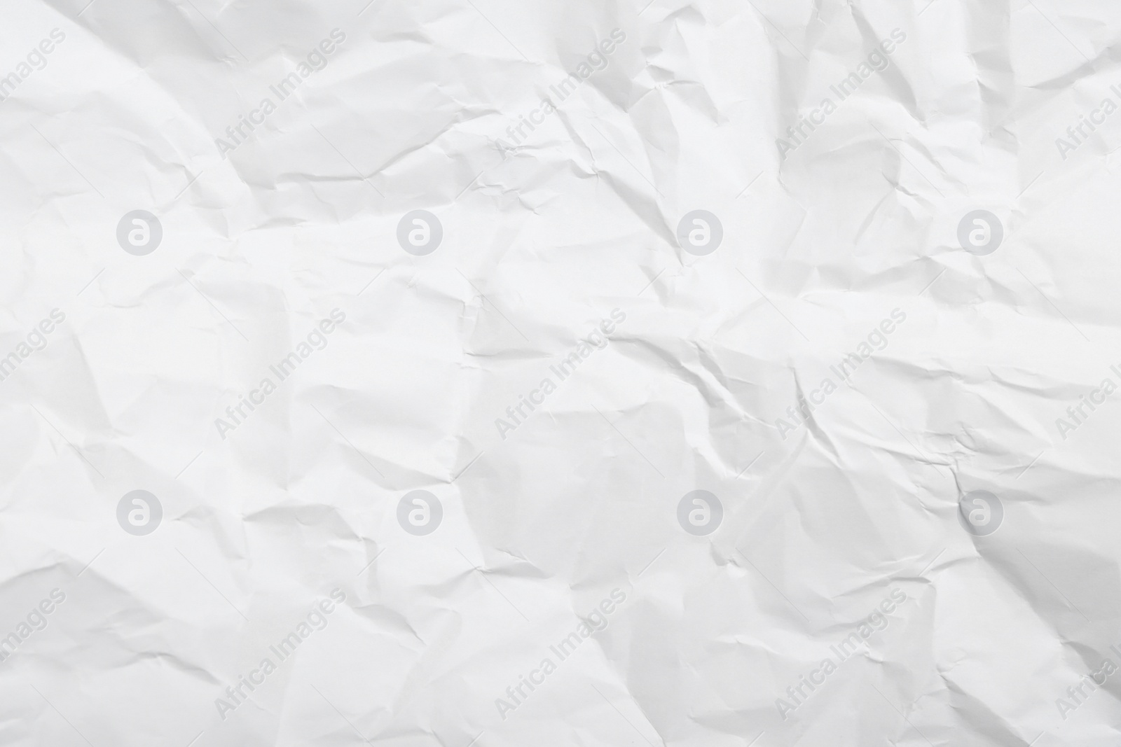 Photo of Sheet of white crumpled paper as background, closeup