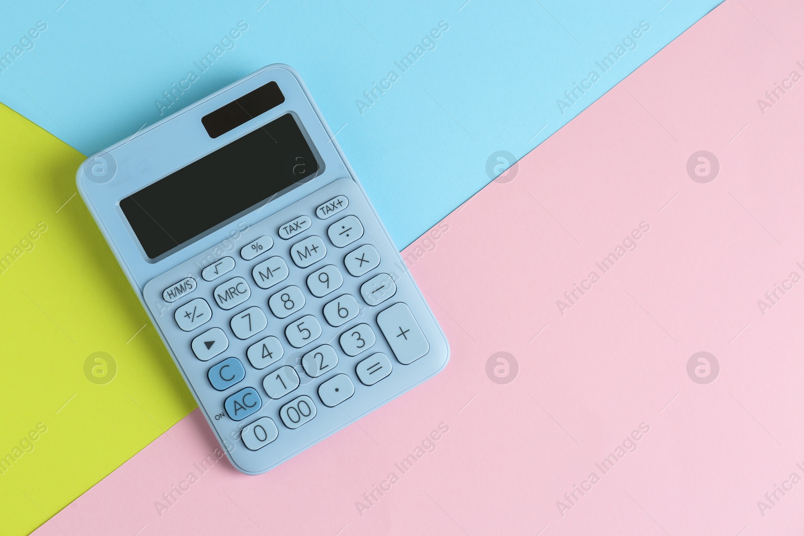 Photo of Modern calculator on color background, top view. Space for text