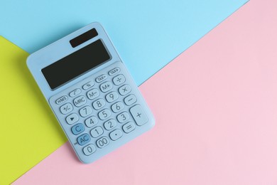 Modern calculator on color background, top view. Space for text