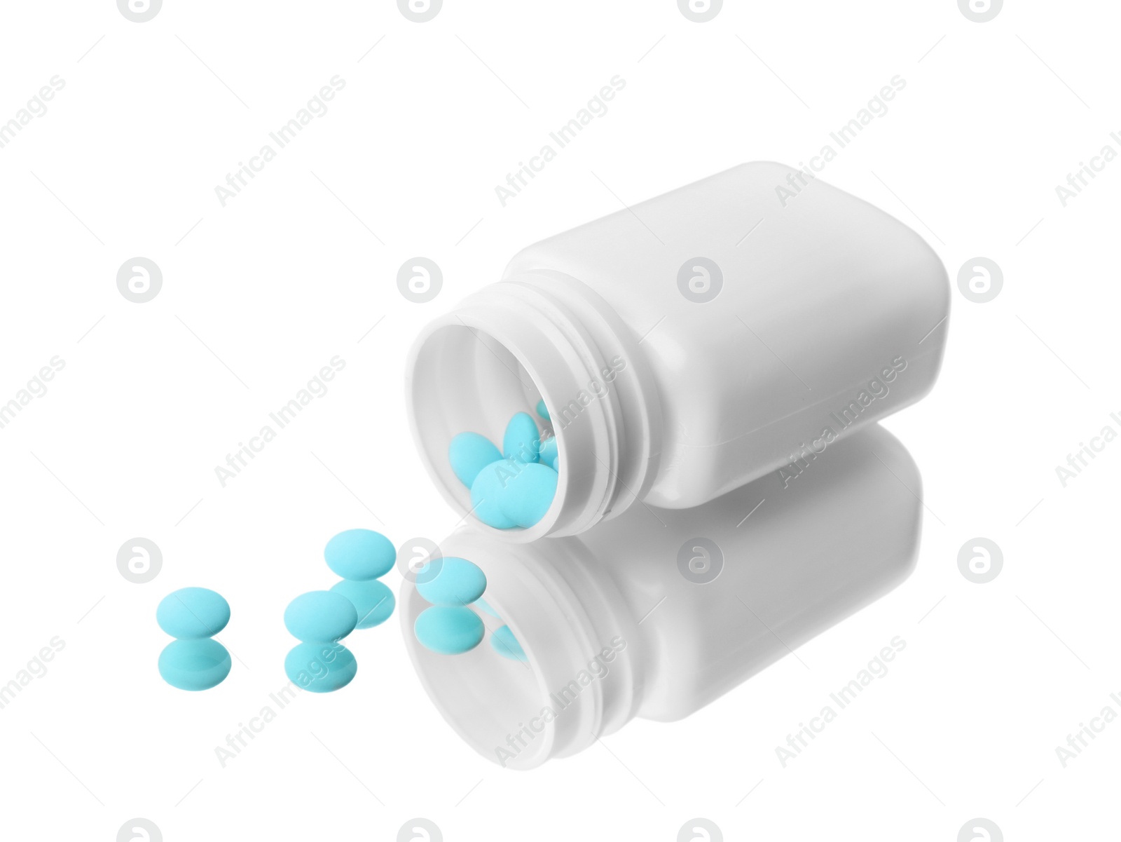 Photo of Bottle with pills on mirror surface