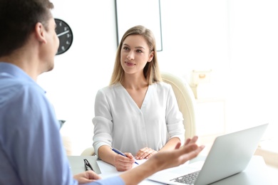 Human resources manager conducting job interview with applicant in office