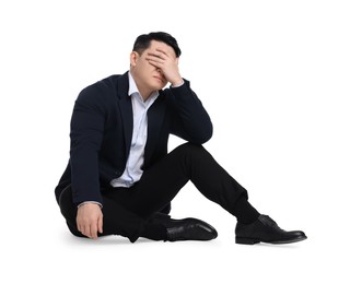 Photo of Tired businessman in suit sitting on white background