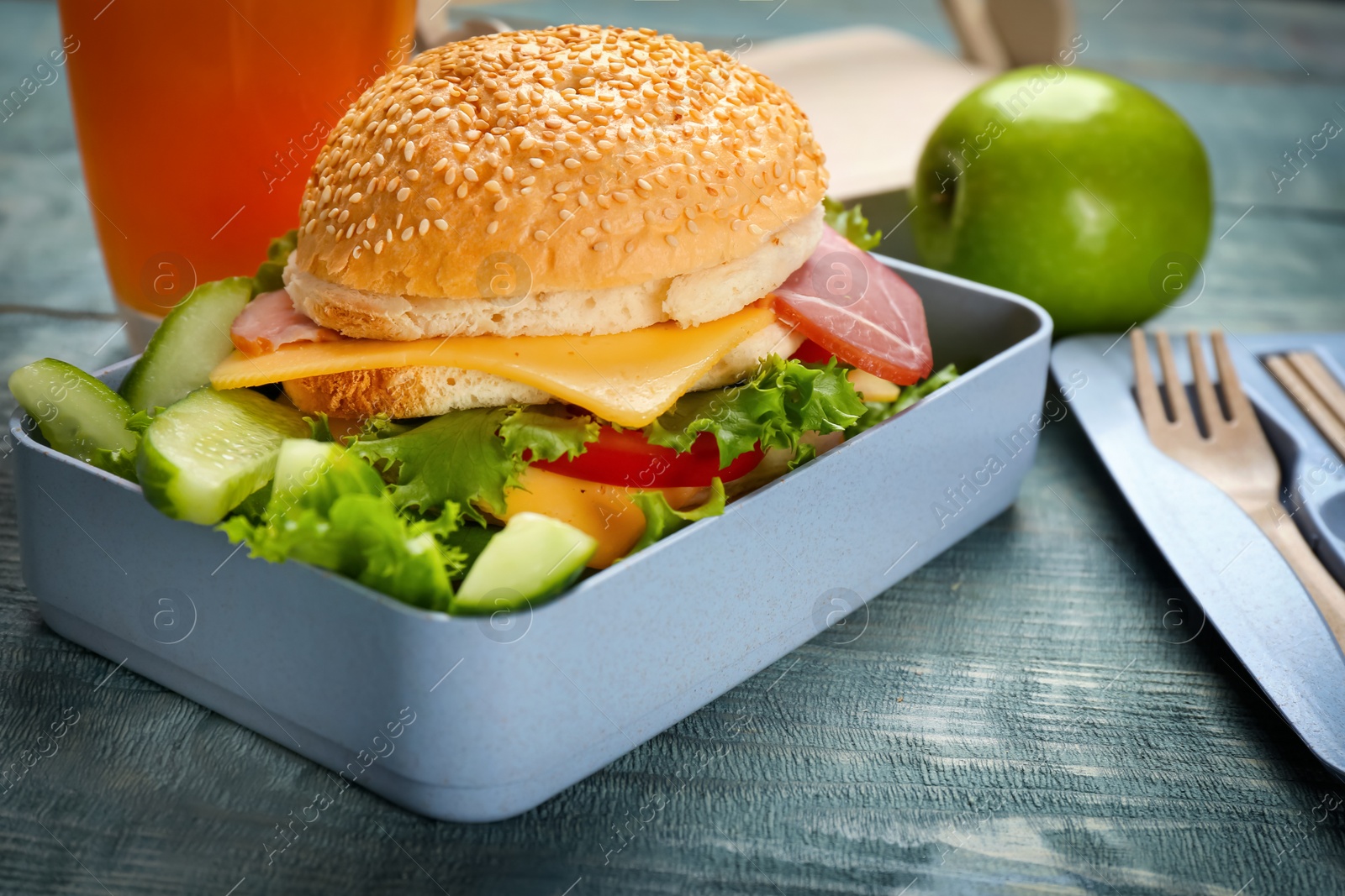 Photo of Lunch box with tasty sandwich on wooden table