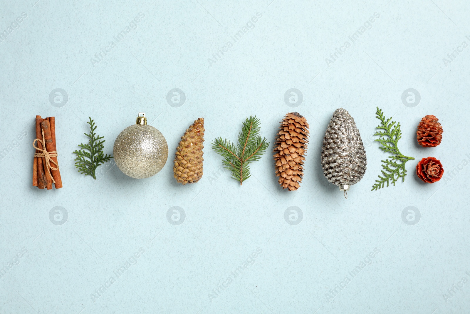 Photo of Flat lay composition with pinecones on light blue background