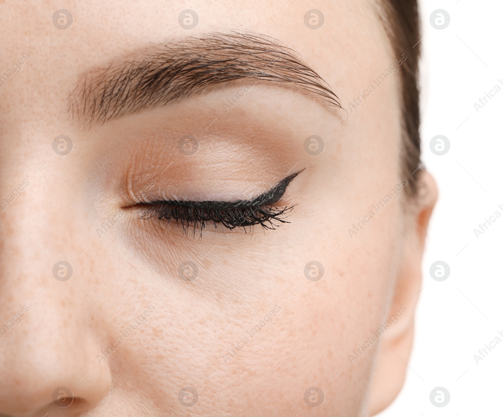 Photo of Makeup product. Woman with black eyeliner and beautiful eyebrow on white background, closeup