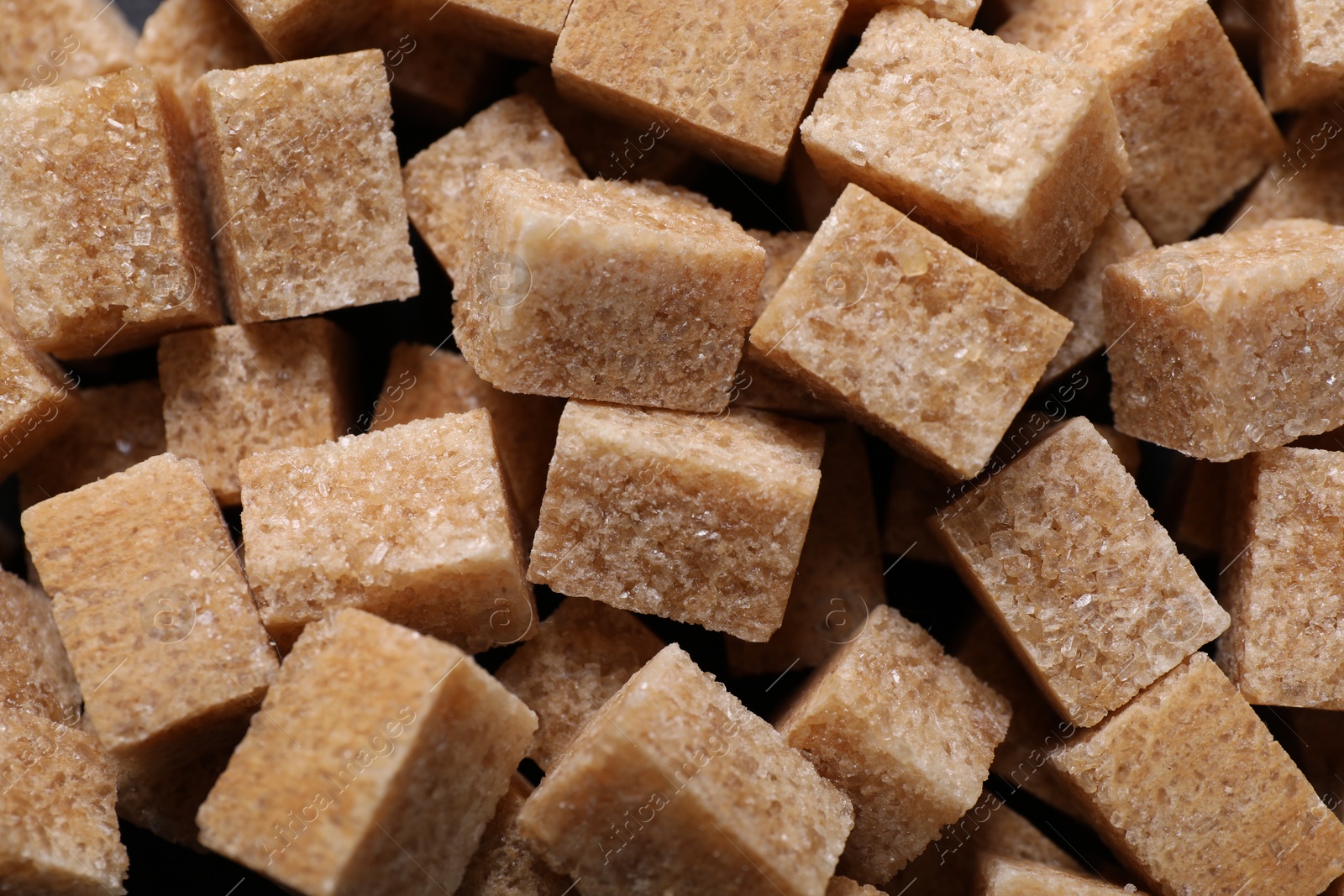 Photo of Brown sugar cubes as background, top view