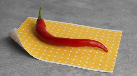 Photo of Pepper plaster and chili on grey textured background, closeup