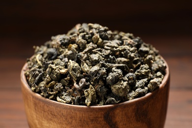 Photo of Bowl of Tie Guan Yin oolong tea leaves on table, closeup