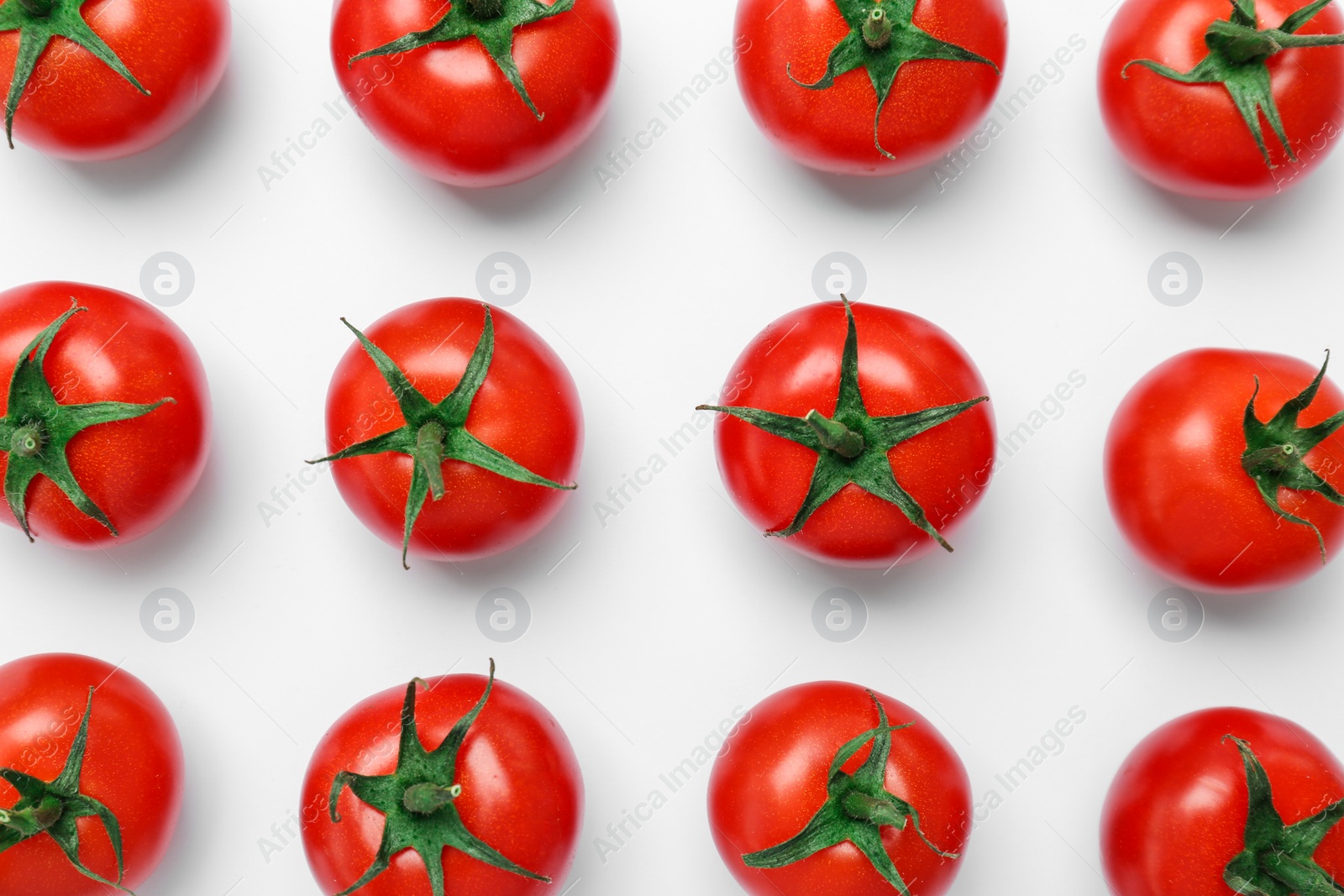 Photo of Flat lay composition with ripe tomatoes on light background