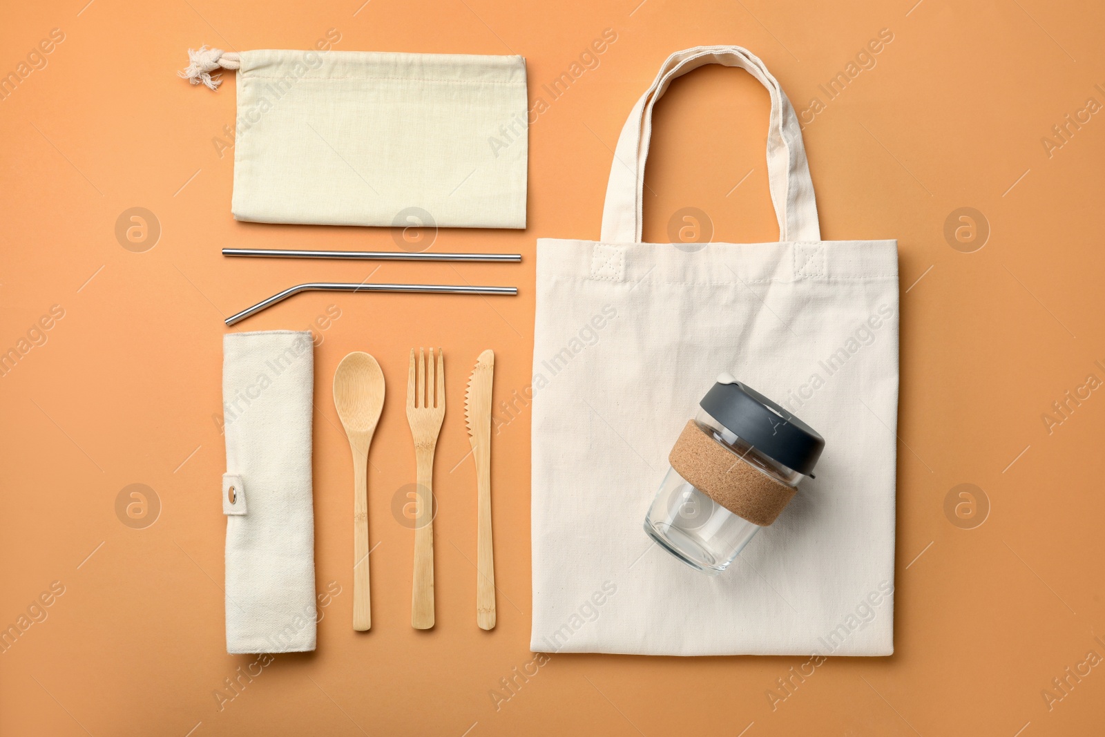 Photo of Flat lay composition with eco friendly products on pale orange background