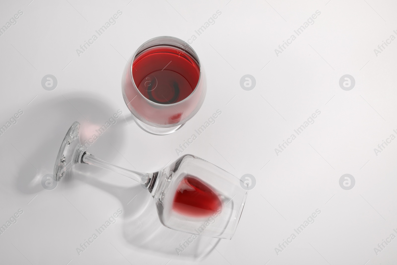 Photo of Tasty red wine in glasses isolated on white