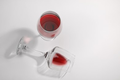 Photo of Tasty red wine in glasses isolated on white