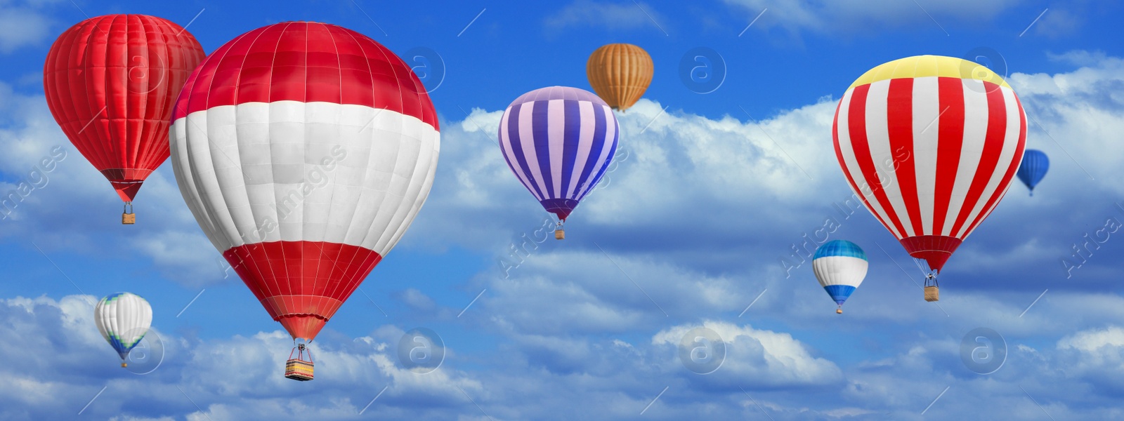 Image of Many bright hot air balloons flying in sky, banner design