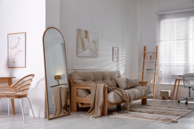 Apartment interior with large mirror and different furniture