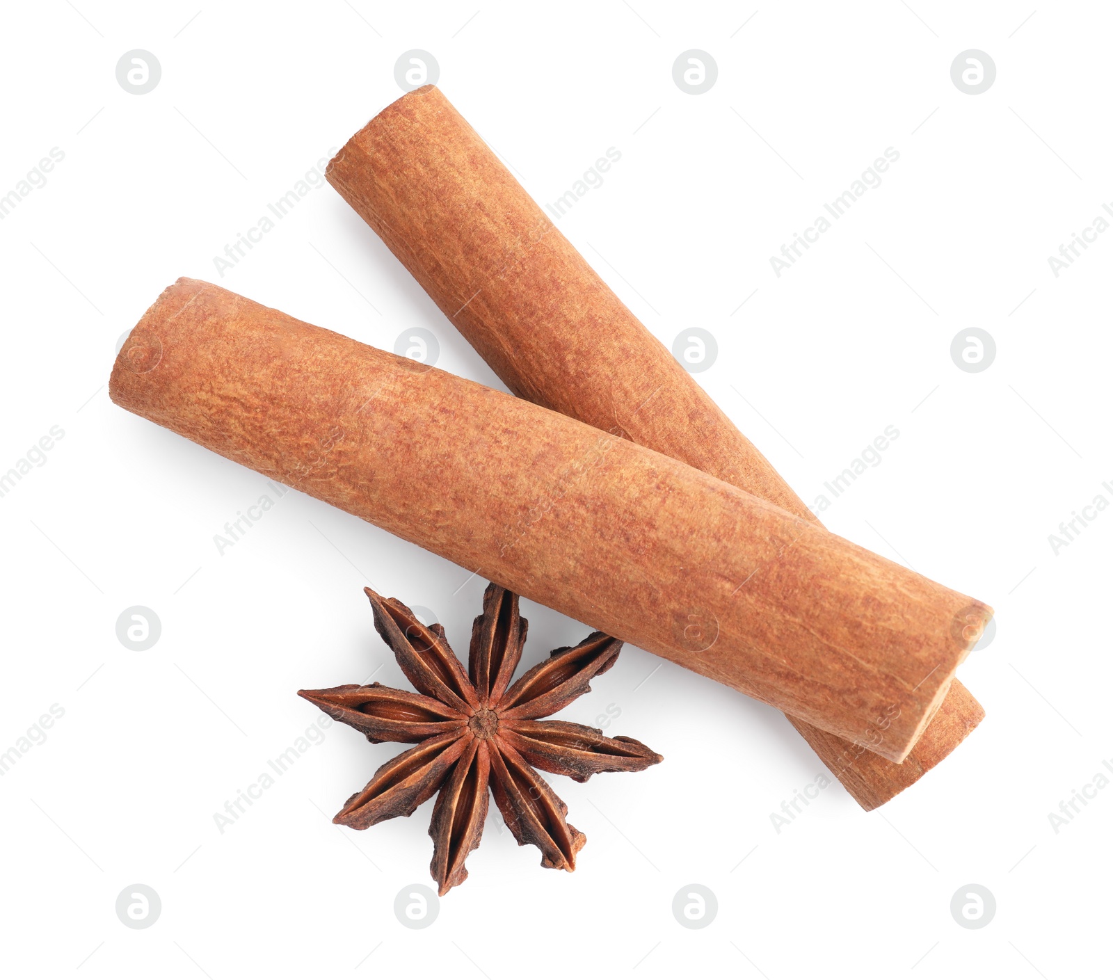 Photo of Aromatic cinnamon sticks and anise star isolated on white, top view