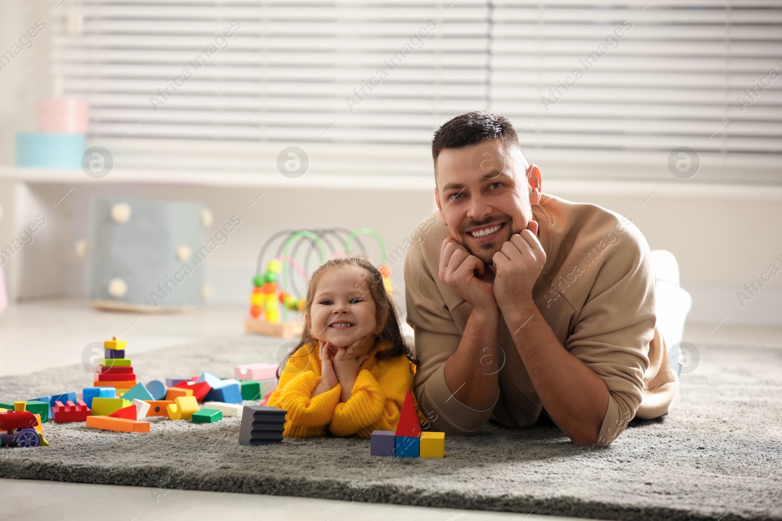 Photo of Father playing with his child at home