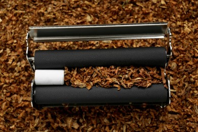 Photo of Roller with filter and tobacco, closeup view. Making hand rolled cigarette