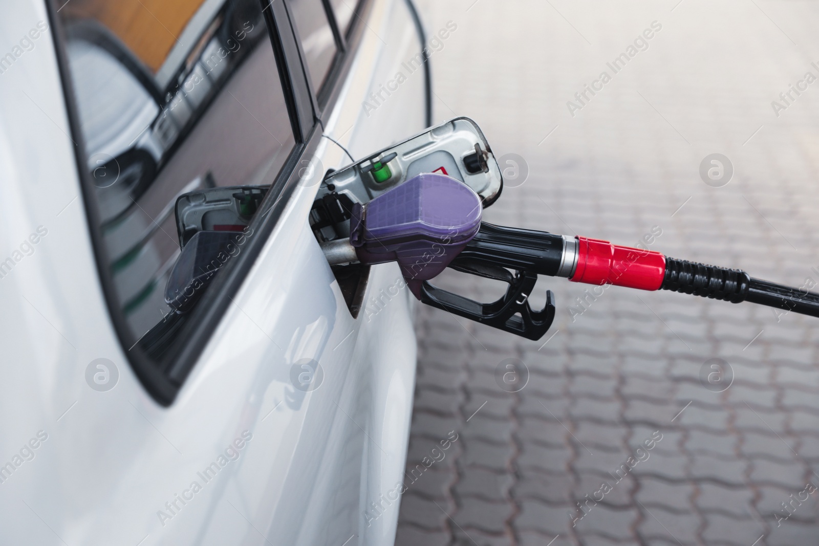 Photo of Refueling modern car at gas filling station, closeup