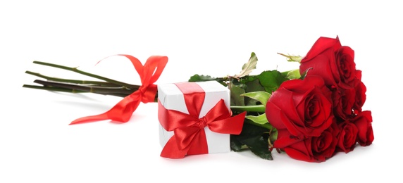 Photo of Beautiful red roses and gift box on white background. St. Valentine's day celebration