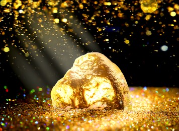 Gold dust and gold nugget on black background