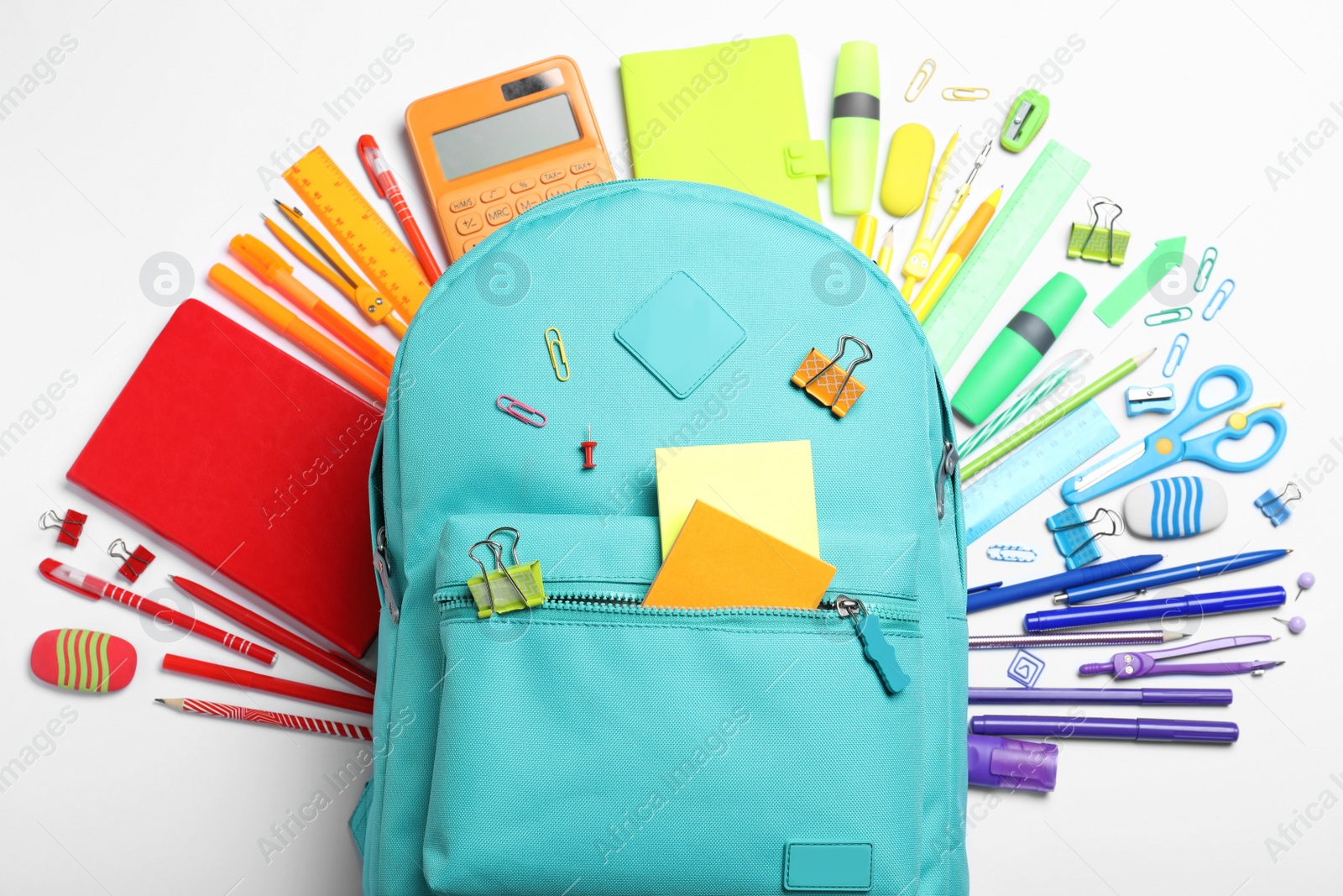 Photo of Stylish backpack with different school stationery on white background, top view