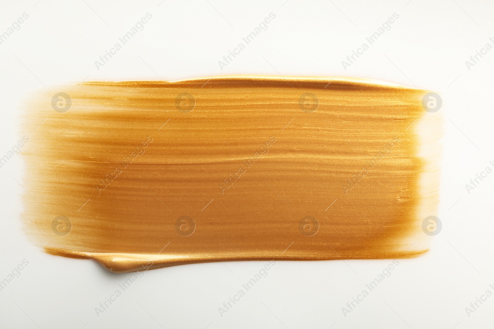 Photo of Stroke of gold paint isolated on white, top view