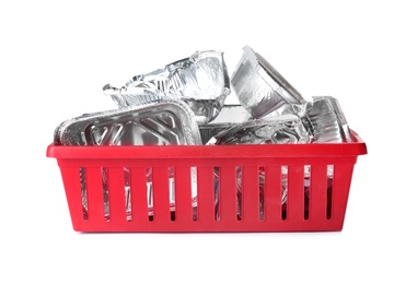 Photo of Crate with used foil containers on white background. Trash recycling