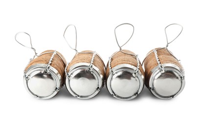 Sparkling wine corks with muselet caps on white background