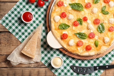 Photo of Flat lay composition with tasty homemade pizza on wooden table