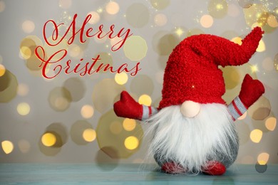Image of Merry Christmas! Cute gnome on turquoise wooden table against blurred festive lights, bokeh effect
