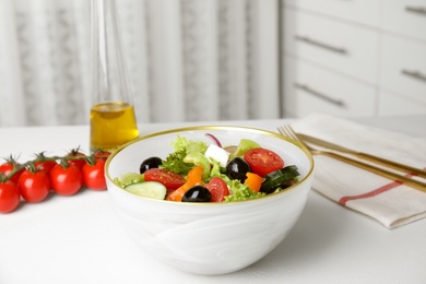 Photo of Tasty fresh Greek salad on white table