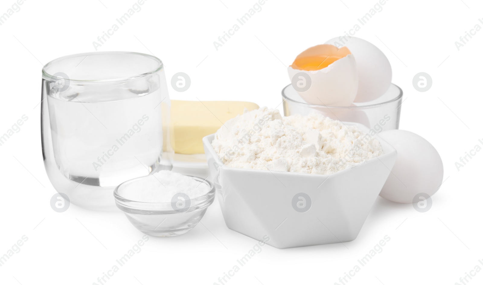 Photo of Eggs, butter, flour, salt and water isolated on white. Ingredients for puff pastry dough