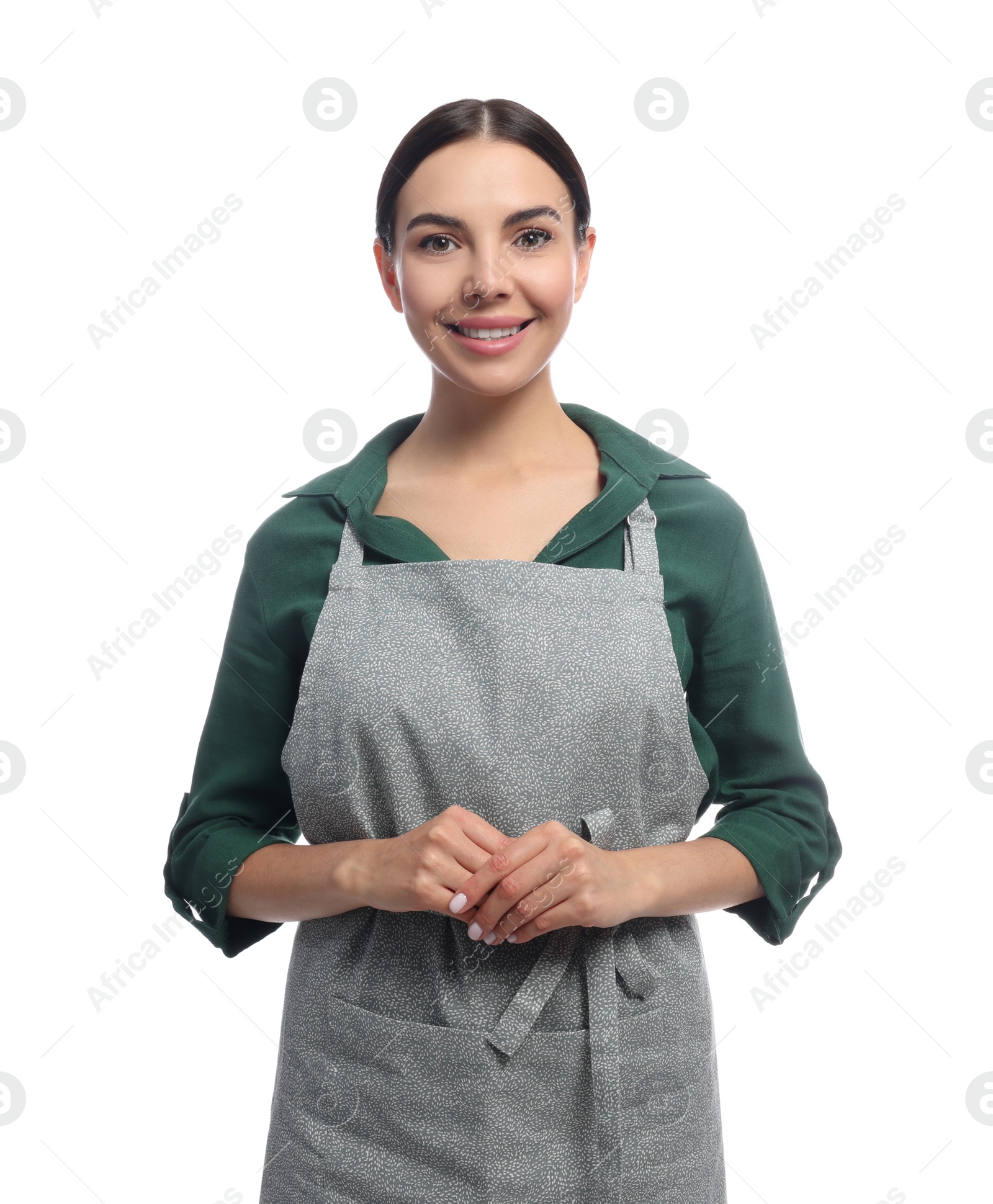 Photo of Young woman in grey apron on white background