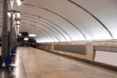 Photo of Spacious subway station with sitting places. Public transport