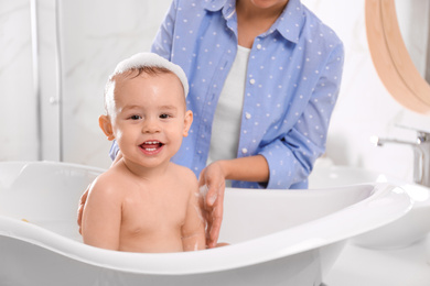 Mother with her little baby in bathroom