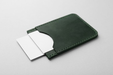 Photo of Leather business card holder with blank cards on light grey background