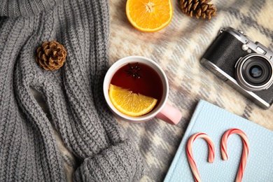 Photo of Flat lay composition with cup of hot mulled wine on blanket. Winter drink