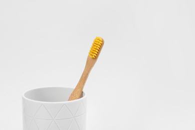 Bamboo toothbrush in holder isolated on white