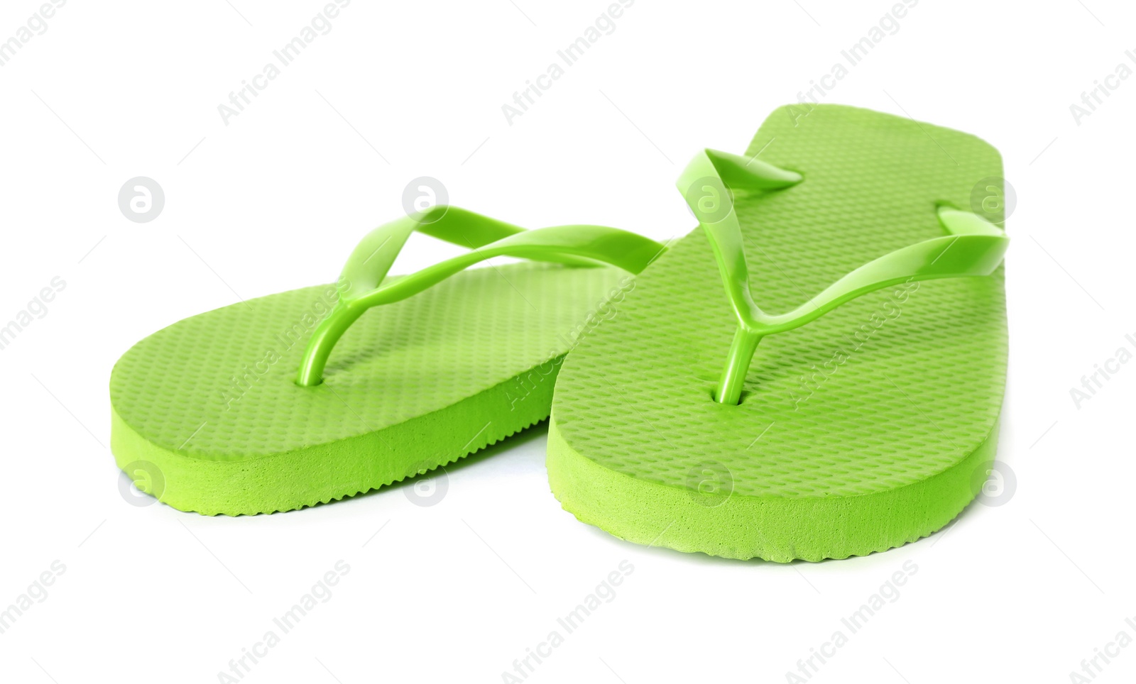 Photo of Bright flip flops on white background. Beach object