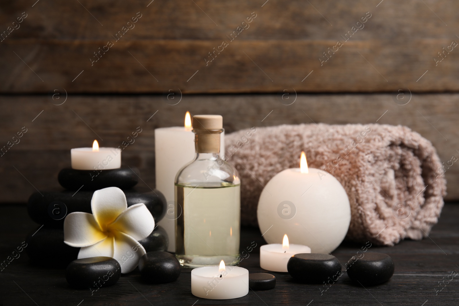 Photo of Spa composition with candles on wooden table