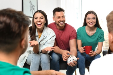 Group of happy people talking in living room