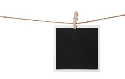 Photo of Clothespin with empty instant frame on string against white background. Space for text