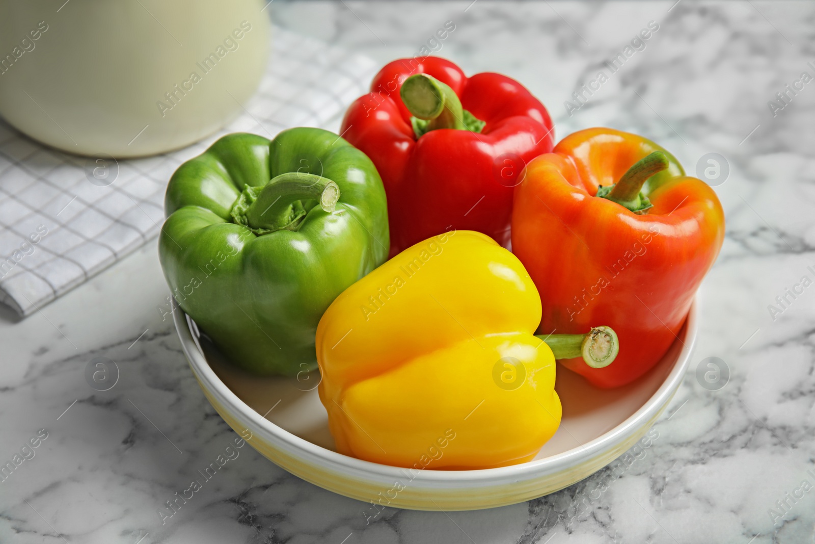 Photo of Bowl with ripe paprika peppers on table